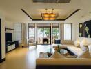 Spacious living room with modern furnishings and a view of an outdoor patio