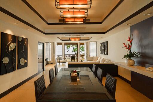 Spacious and well-lit living room with modern decor and a view of the outside patio