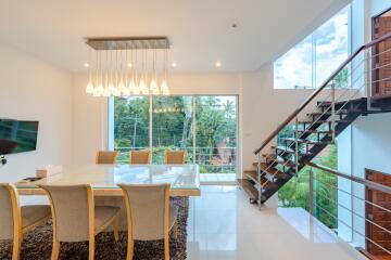 Modern dining room with glass table and pendant lights
