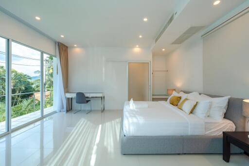Modern minimalist bedroom with large windows