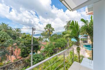 Balcony with scenic view of lush greenery and distant water body