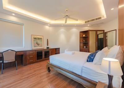 A well-lit bedroom with modern decor and amenities