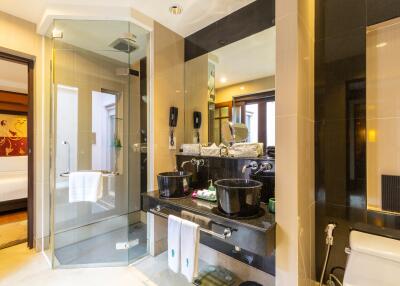 Modern bathroom with double sinks and glass shower