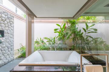 luxurious bathroom with large bathtub and garden view