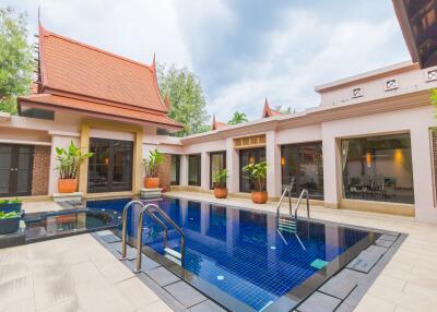 Outdoor pool area with plants and traditional architecture