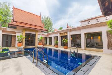 Outdoor pool area with plants and traditional architecture