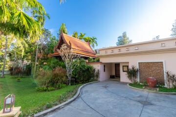 Exterior view of house with lush garden