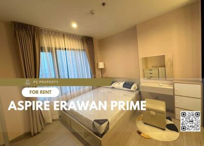 A cozy bedroom with a large window and modern furnishings at Aspire Erawan Prime.