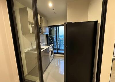 Modern laundry room with washing machine and shelving