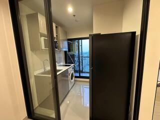 Modern laundry room with washing machine and shelving