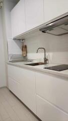 Modern kitchen with white cabinets and stainless steel appliances