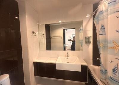 Modern bathroom with large mirror and integrated sink