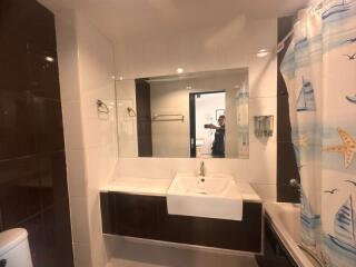 Modern bathroom with large mirror and integrated sink