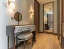 A modern hallway with a vanity table and mirror