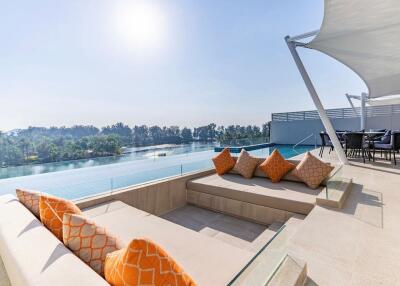 Spacious outdoor lounging area with infinity pool and scenic views