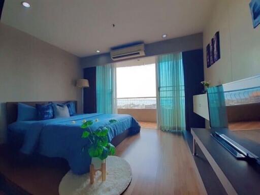 Modern bedroom with large window and blue theme