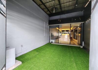 Enclosed patio space with artificial grass flooring