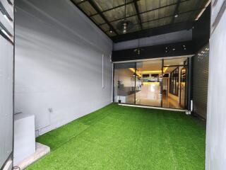 Enclosed patio space with artificial grass flooring