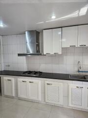 Modern kitchen with white cabinets and stainless steel appliances