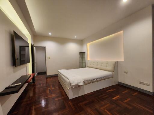 Modern bedroom with a large bed and wall-mounted TV