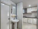 Modern white-tiled kitchen with built-in cabinets