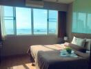 Bright bedroom with large window and sea view