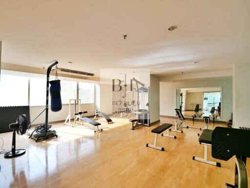 Spacious home gym with various exercise equipment