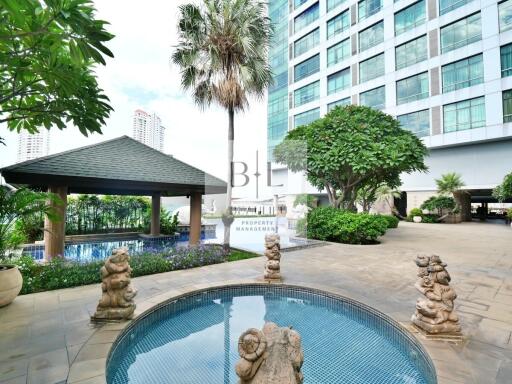 Modern residential building with outdoor pool and seating area