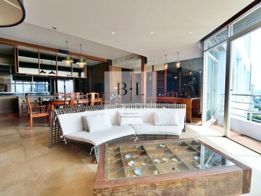 Spacious living room with modern furnishings and floor-to-ceiling windows