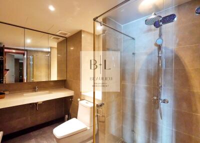 Modern bathroom with glass shower and large mirror
