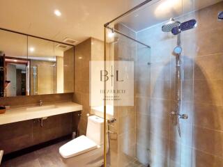 Modern bathroom with glass shower and large mirror