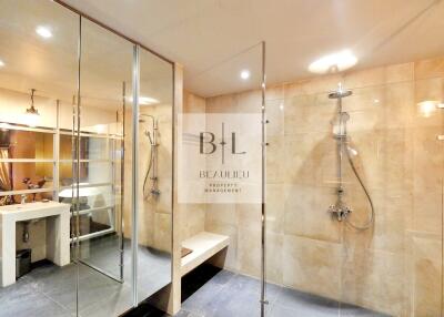 Spacious modern bathroom with glass-enclosed showers