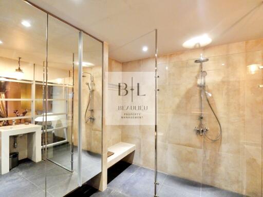 Spacious modern bathroom with glass-enclosed showers