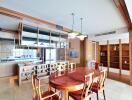 Spacious dining room with wooden table and chairs, modern lighting, and built-in shelves.