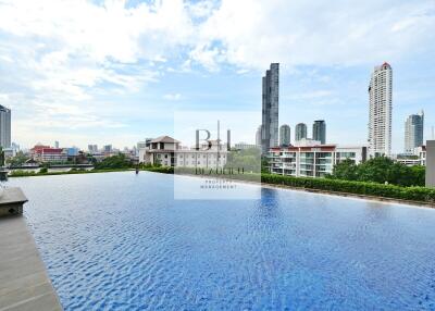 Outdoor swimming pool with cityscape view