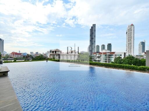 Outdoor swimming pool with cityscape view