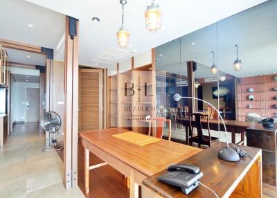 Modern dining area with wooden table and mirrored wall
