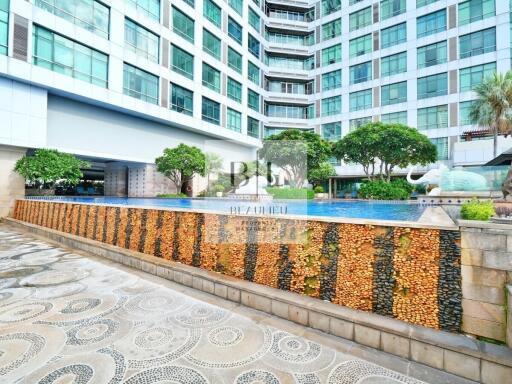 Modern residential building with outdoor pool and green areas