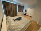 Modern bedroom with striped bedding and large window