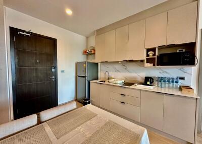 Modern kitchen with light beige cabinets and dining area