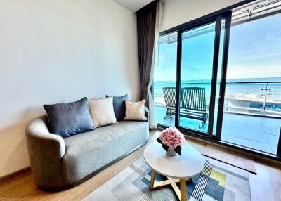 Modern living room with large window offering sea view