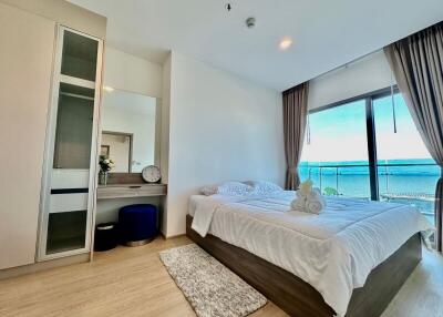 Bedroom with a large window and sea view