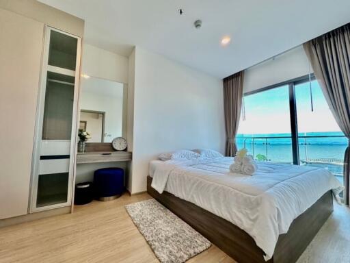 Bedroom with a large window and sea view