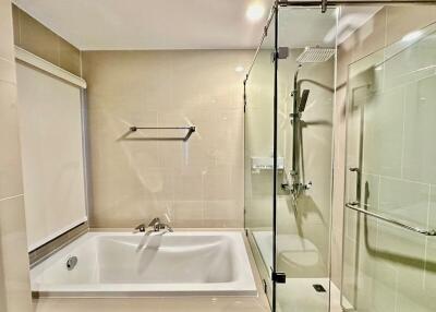 Modern bathroom with bathtub and glass shower