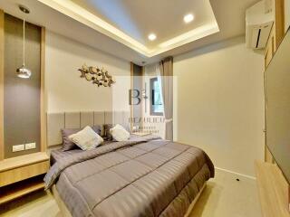 Modern bedroom with bed, pillows, and decorative elements