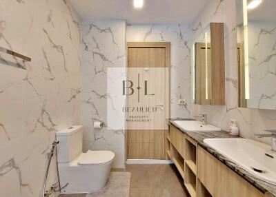 Modern bathroom with marble walls and double vanity