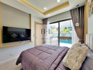 Modern bedroom with a pool view