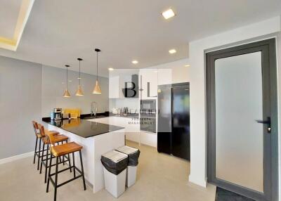 Modern kitchen with island seating and built-in appliances