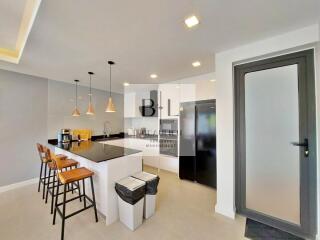 Modern kitchen with island seating and built-in appliances