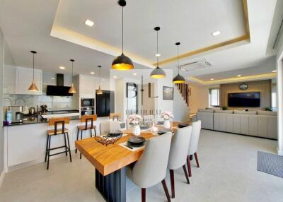 Modern open-plan kitchen and living area with dining table